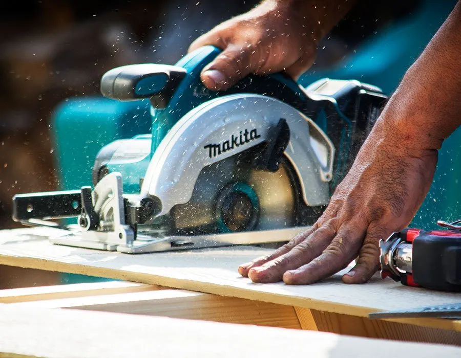 Choice Roofs Designs - myheartcreative A professional image of a worker using a table saw to cut wood.