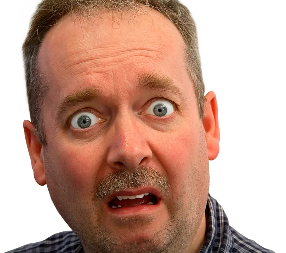 A man with a scared look on his face. His eyes are wide. 
