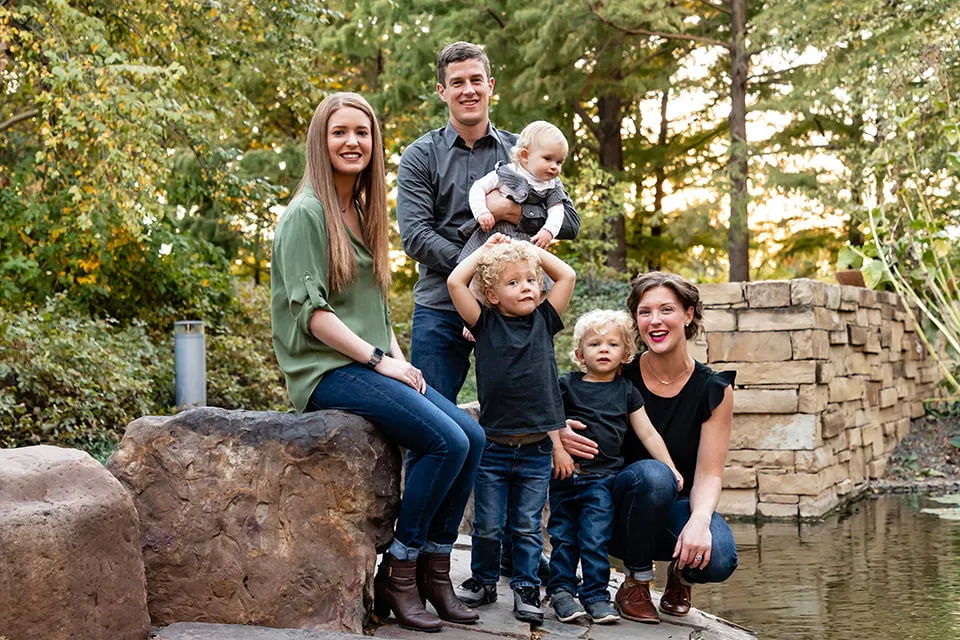 Looking Back on a Year of Web Design OKC - myheartcreative A family of six smile for a group photo in an outdoor garden area.