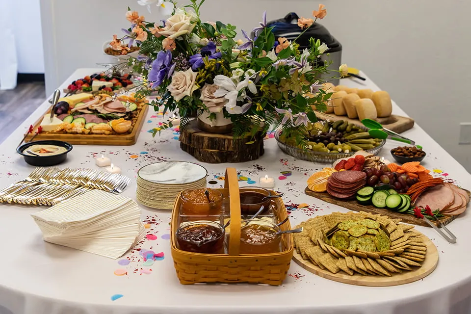 Looking Back on a Year of Web Design OKC - myheartcreative The myheartcreative conference room is turned into a food table. There is a colorful floral arrangement in the middle, with a variety of snacks surrounding it.
