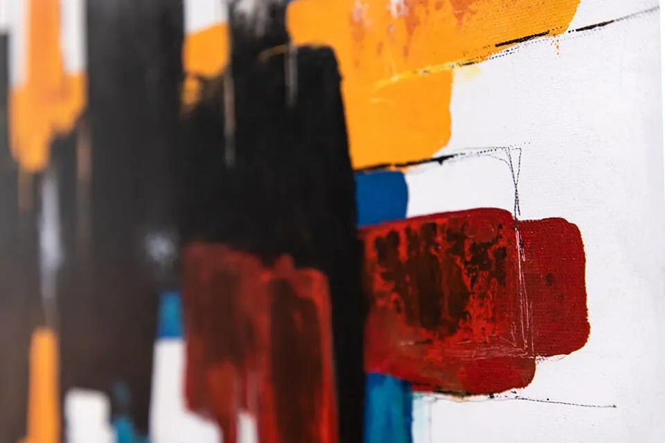 An up-close shot of Keith Wolfe's abstract painting, "Grown." The painting features a color-block pattern using red, blue, yellow, and black. 