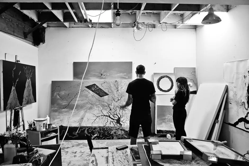 Make work. - myheartcreative A male and female artist stand and talk about a painting at the In The Make studio.