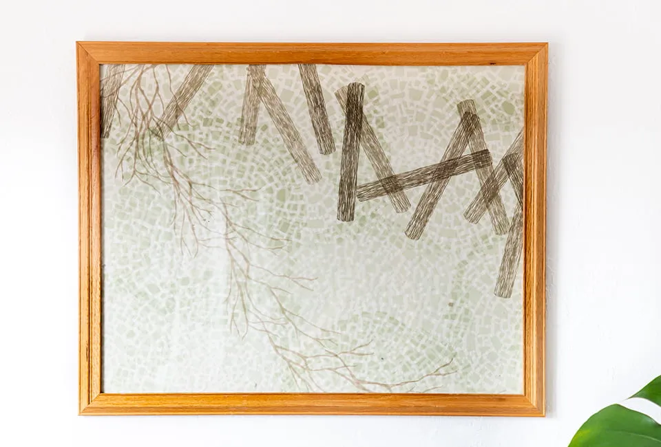 An abstract piece by artist Emma Difani in a light wooden frame. 
