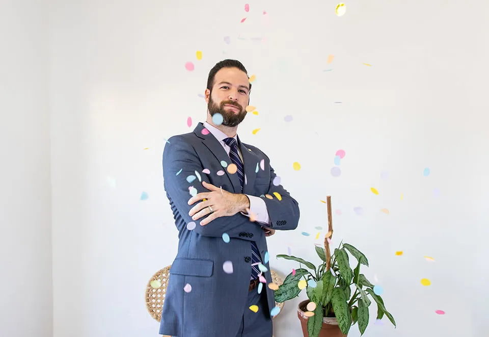 Looking Back on a Year of Web Design OKC - myheartcreative A myheartcreative client poses with his arms crossed as confetti is thrown on him at the client party.