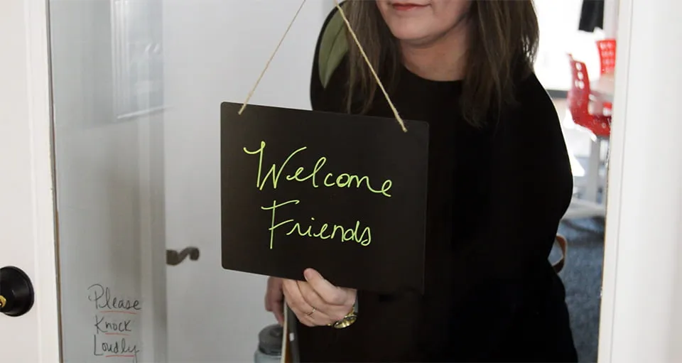 The Personal Touch - myheartcreative Amy flips a sign on the front door of the studio. The sign reads "Welcome Friends."