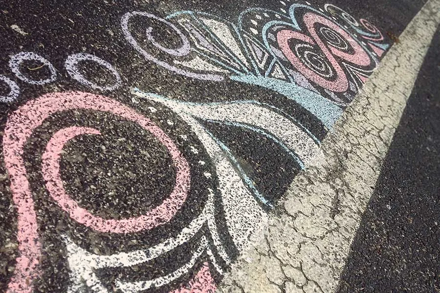 Abstract swirl chalk designs on concrete. 