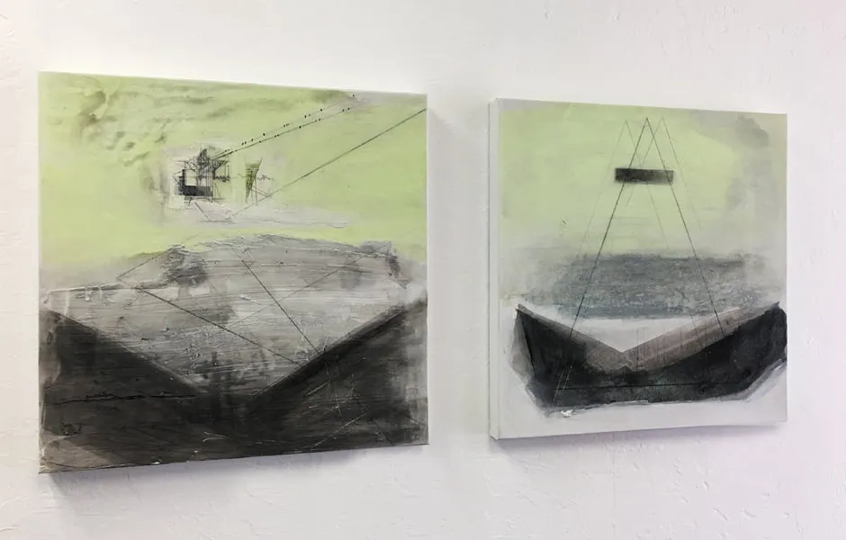 Two abstract paintings by Brandi Downham hang on the studio conference room wall. 