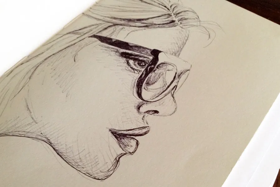 A sketch of a woman's side profile in pen. 