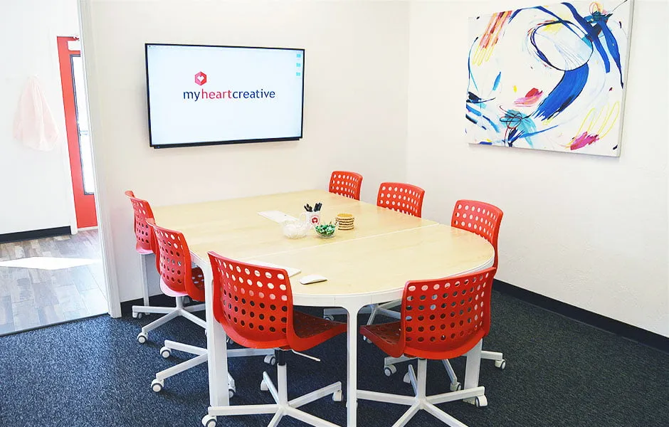 Space Altering Creator - myheartcreative A large, multi-colored abstract painting by artist Katelynn Noel Knick hangs in the conference room of the studio.