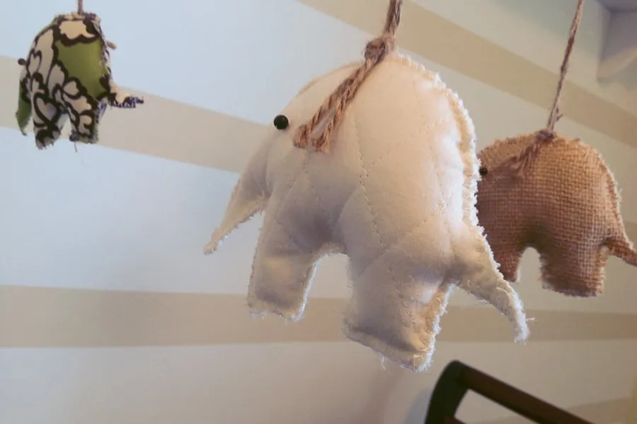 A mobile with hand-sewn elephants made from quilt materials. 