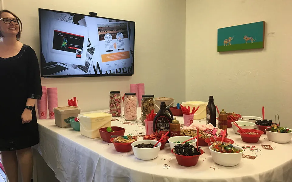 2018 Reflections and 2019 Projections - myheartcreative April stands by the conference room table, which has been transformed for the ice cream social. The table has bowls of different toppings, tubs of ice cream, and red spoons.