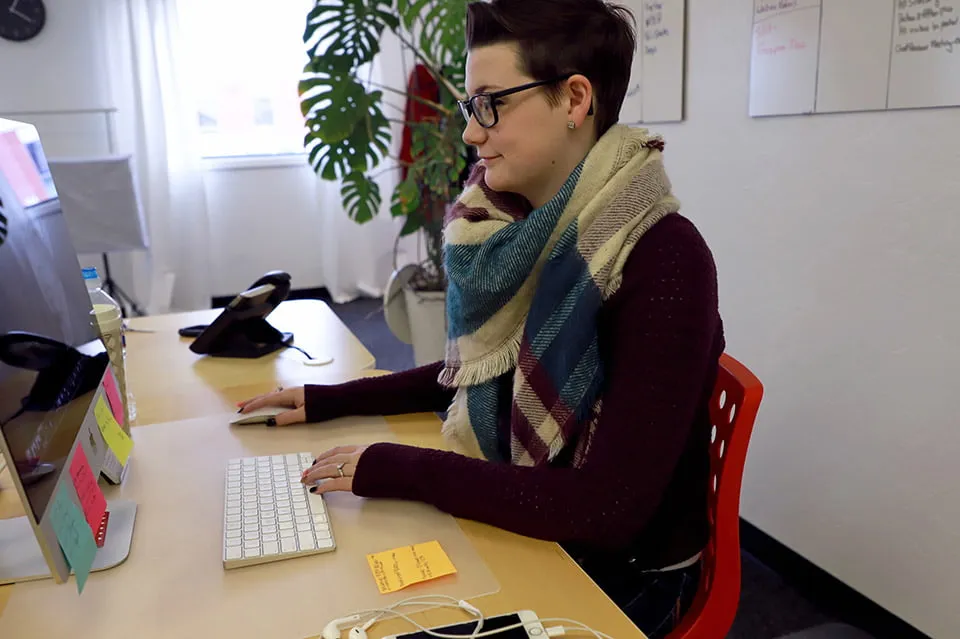 Morgan Denny editing photos on her desktop at her desk. 