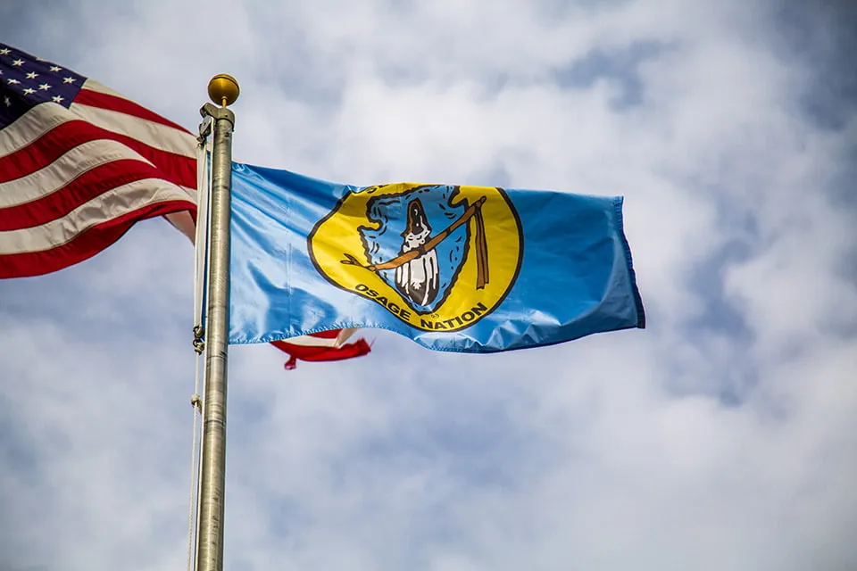 The Osage Nation and American flags fly in the wind, as shot by myheartcreative Oklahoma photography services. 