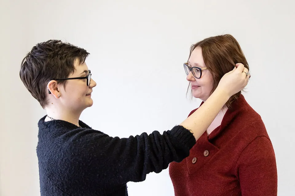 myheartcreative photographer Morgan fixes April's hair to pose her for a photo. 