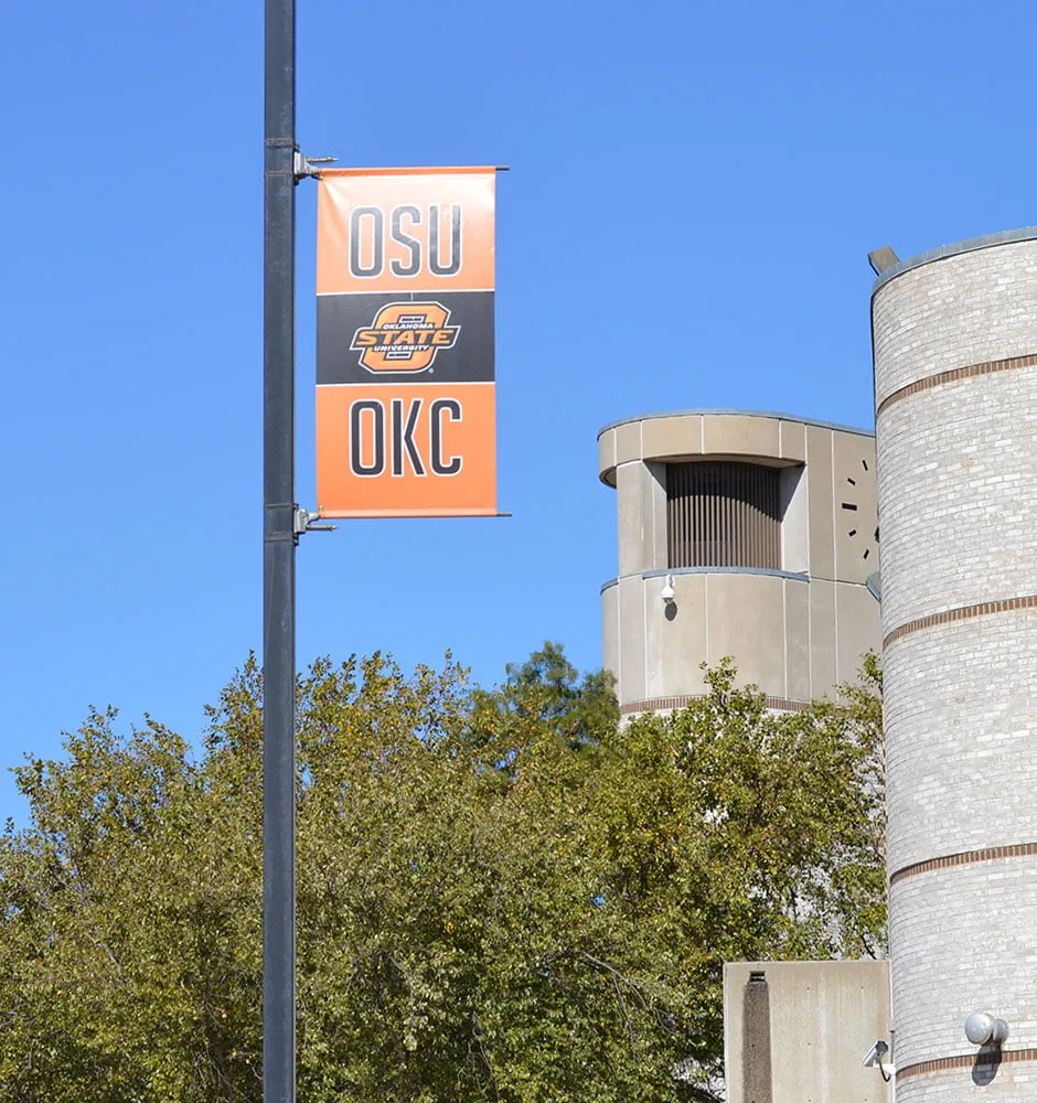A pole banner for OSU OKC on campus. 