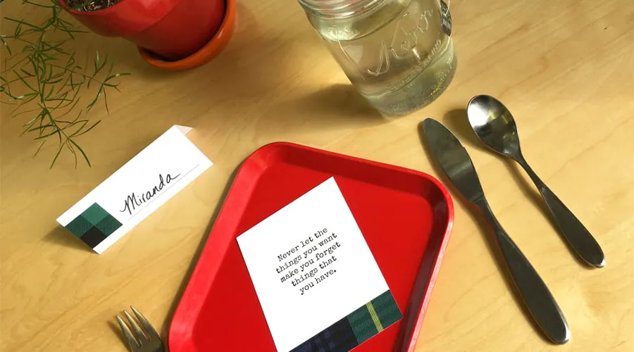 The Thanksgiving plate card sits on a red place setting. The name card reads, "Miranda." 