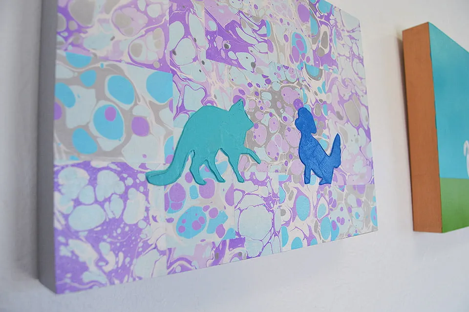 Dialectic Tendencies - myheartcreative A painting by Kerri Shadid. The painting hows an outline of a cat and a dog painted in blue. The background is an abstract mix of colors.