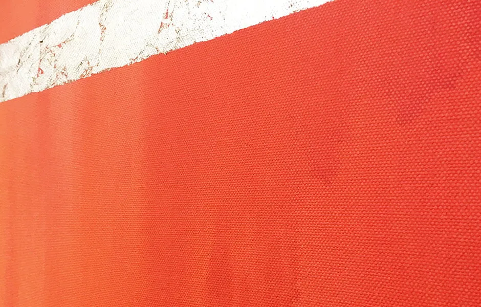 An up-close shot of a dark orange painting on canvas by Sara Day-Short. 
