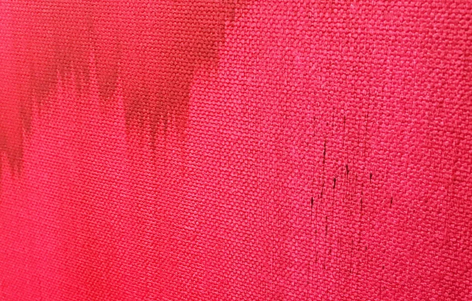 An up-close shot of a magenta painting on canvas by Sara Day-Short. 