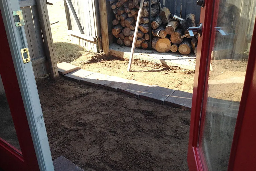 The grass area has been dug up and cement is ready to be laid outside of the new studio's doors. 