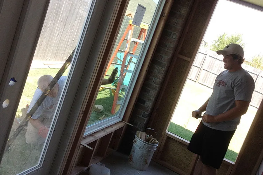 Dustin and Luiz help install the windows at the home studio. 