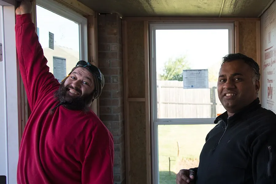 Sam works with a friend on installing the double backdoor at the home studio. 