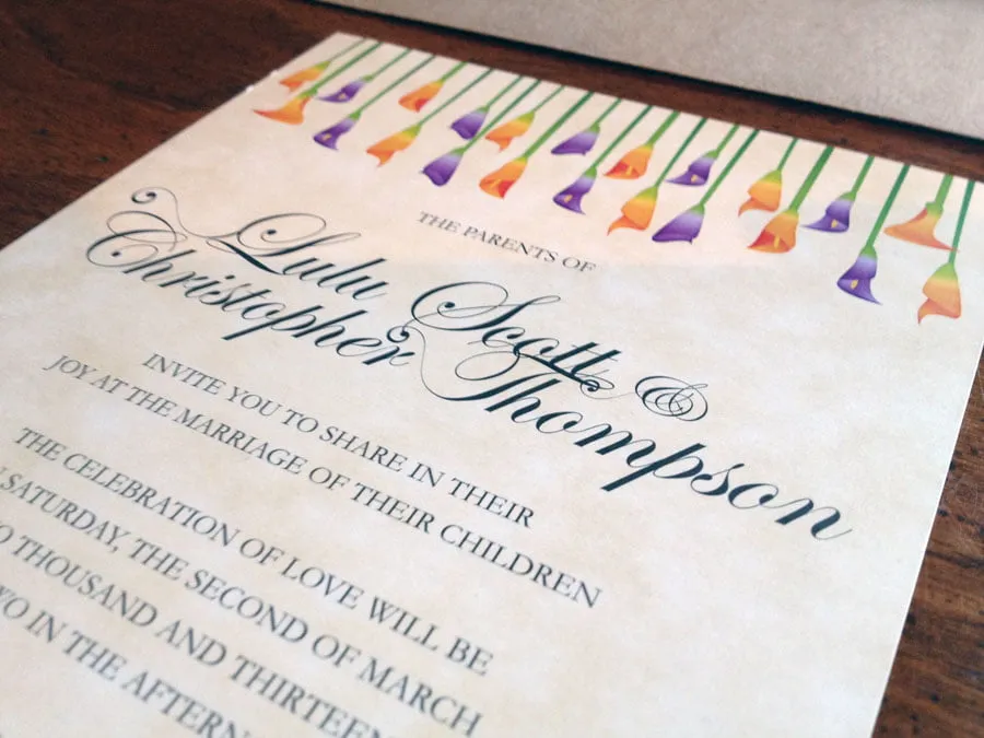 An up-close shot of the Thompson invitation design, with cursive font and orange and purple tulips at the top. 