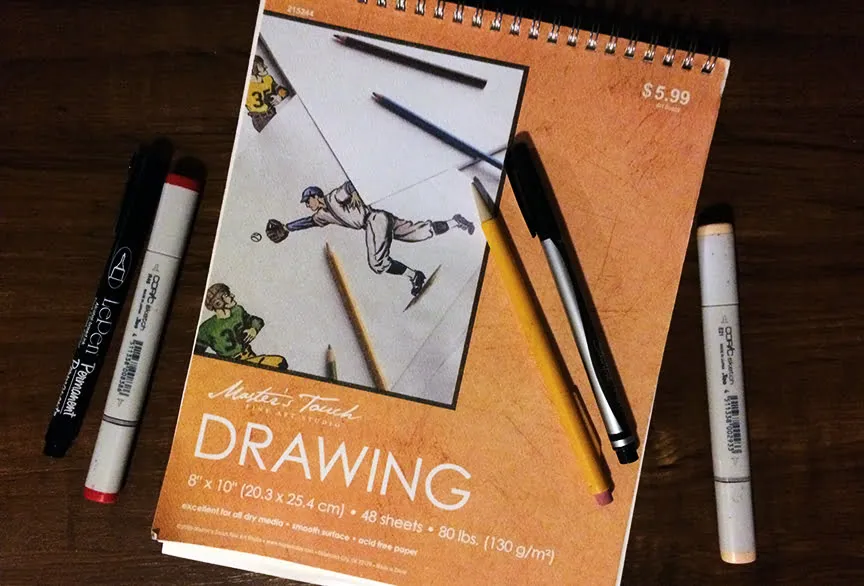 A Sharpie thin pen and a mechanical pencil rest on top of a drawing sketch book. Tree markers lay around the notebook. 