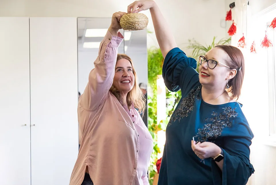 Our Clients Have Our Hearts - myheartcreative Amy holds up a small wicker basket and April draws out a name for door prizes.