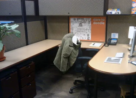 Amy's desk at her office. The "dare to doodle" poster hangs on her cubicle wall. 