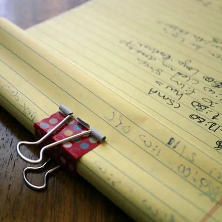 design hours logged - myheartcreative A binder clip holds down the pages on a legal pad where Amy logs her design hours.
