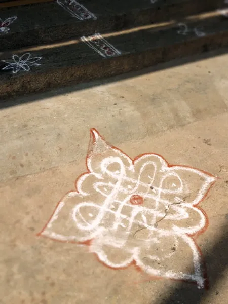 An ornate chalk design on a sidewalk in India. 