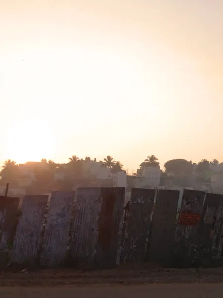 The sunset behind a concrete wall in India. 