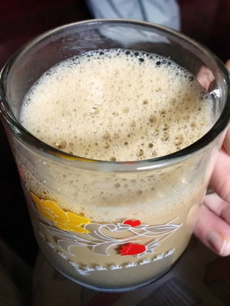A latte in a clear mug. 