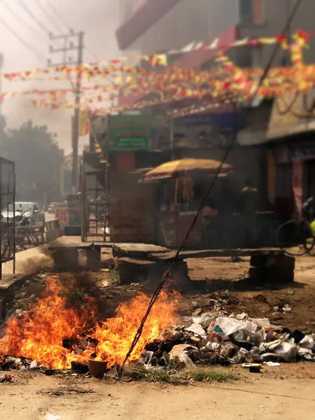 Trash burning on the side of the road in an Indian city. 