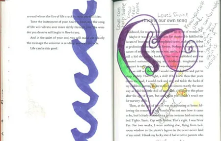 Two pages out of a book. The right page has some notes written by Amy in pencil, along with a heart drawing in purple, pink, and green colors. On the left page is a large purple spiral line drawn from the top to the bottom. 