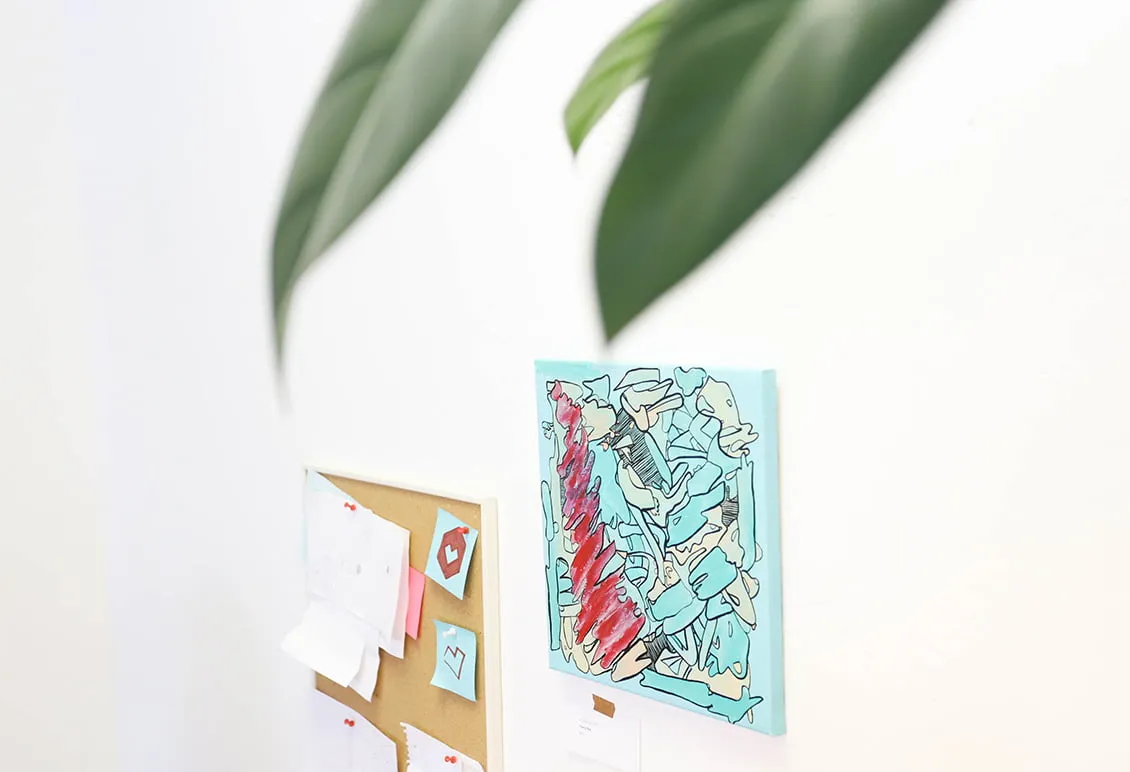 Artistic Healing - myheartcreative A blue abstract painting by artist Bianca Roland hangs on the wall next to a pin board at the creative Oklahoma web design studio.