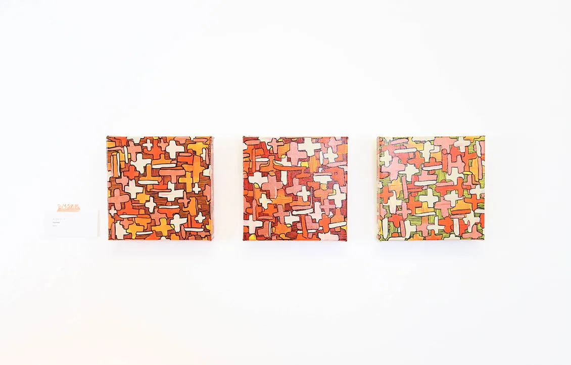 Artistic Healing - myheartcreative Three similar paintings by Bianca Roland hang on the wall at the myheartcreative studio. All three are small, abstract pieces with red and orange palettes.