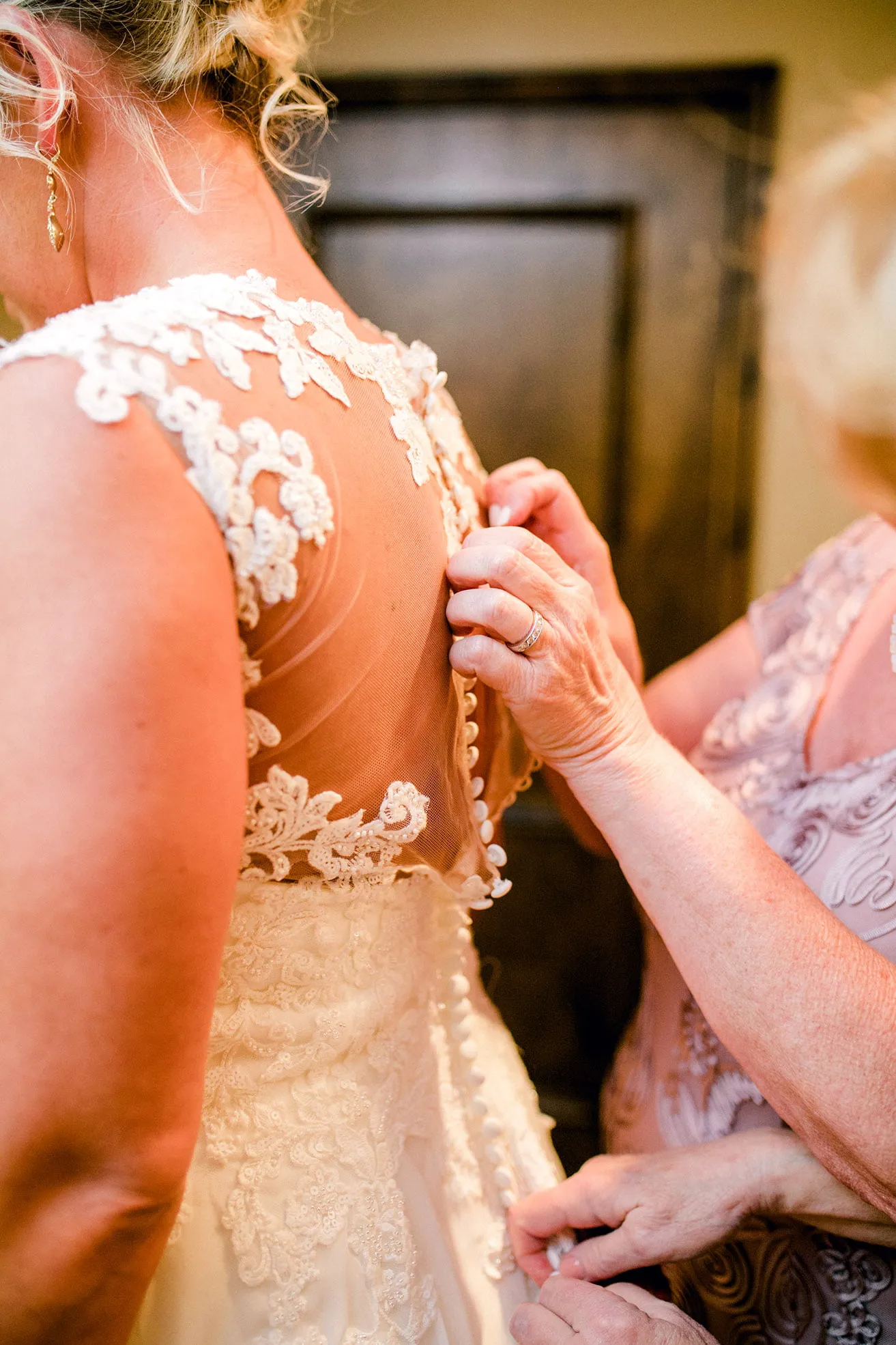 Jeff and Kasey The Palace Wedding - myheartcreative The bride's mother fastens the buttons on the back of the bride's wedding gown.