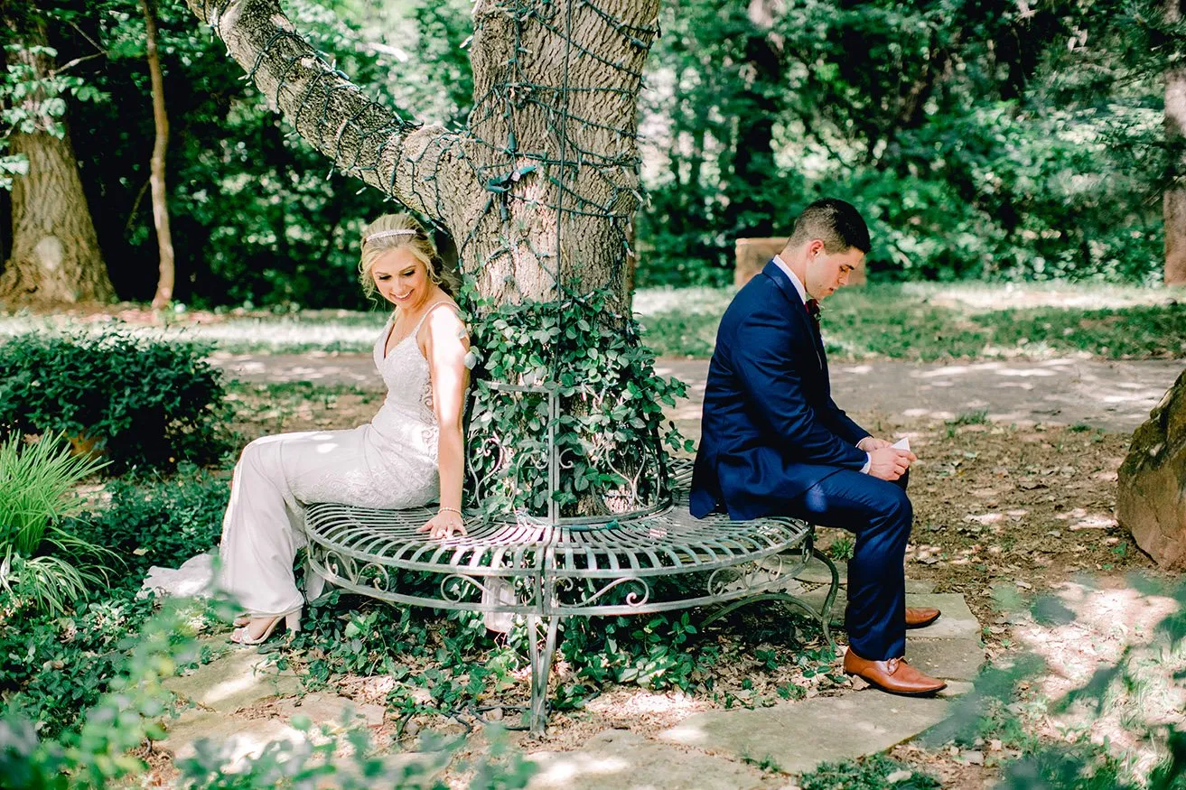 Derek and Shelby Thunderbird Chapel Wedding - myheartcreative Derek and Shelby, the bride and groom, sit up opposite sides of a tree wrapped in twinkle lights. Derek reads his vows to Shelby.