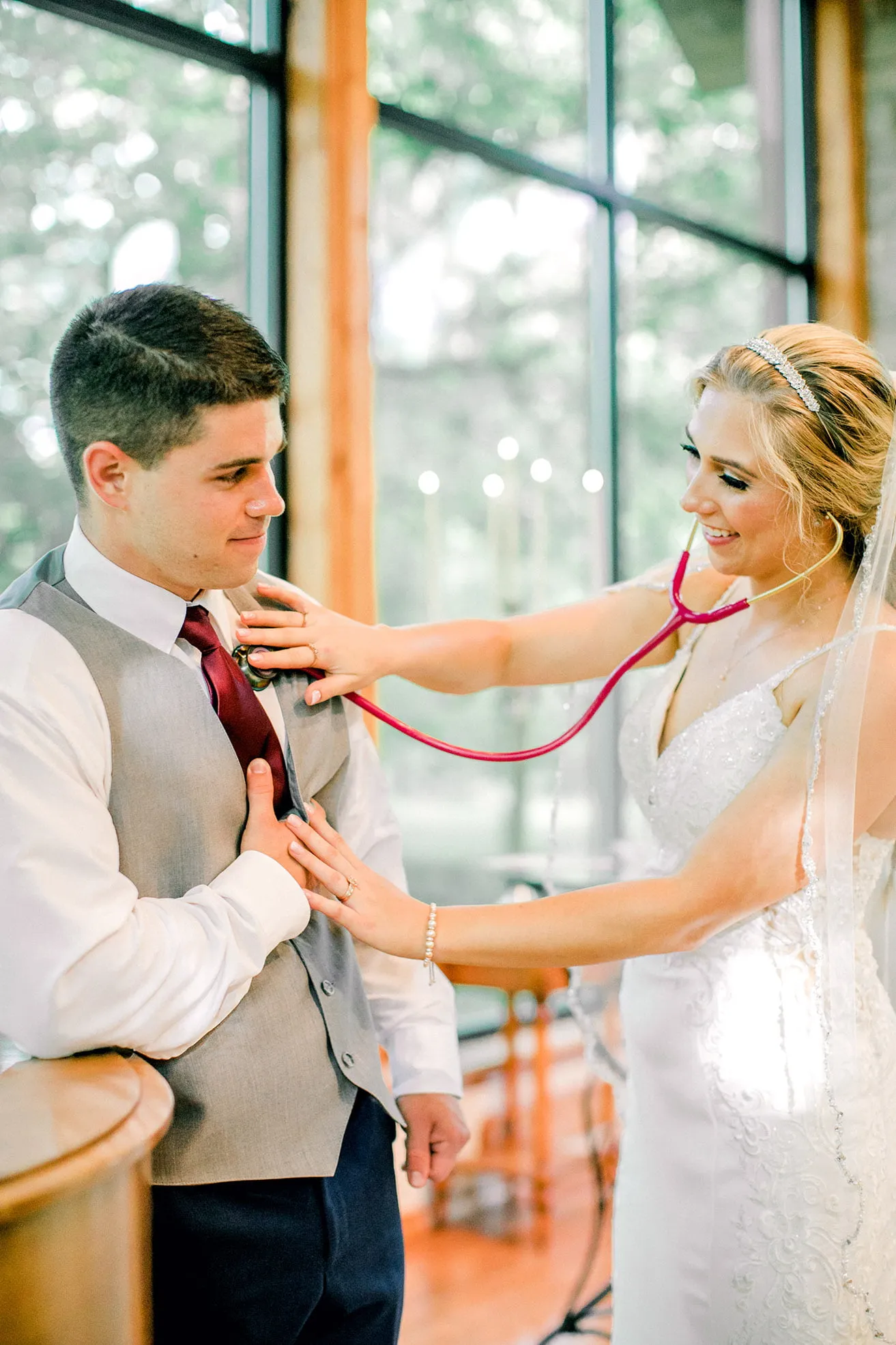 Derek and Shelby Thunderbird Chapel Wedding - myheartcreative Shelby, the bride, uses her stethoscope to listen to Derek's, the groom's, heart after their Oklahoma pandemic wedding ceremony.