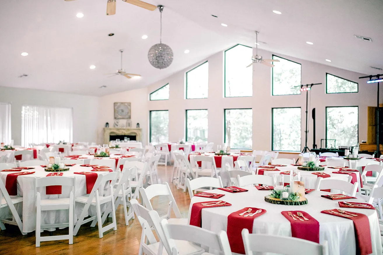 Derek and Shelby Thunderbird Chapel Wedding - myheartcreative The inside of the wedding reception for Derek and Shelby. The tables are complete with white linens and chairs, maroon napkins, and gold silverware.
