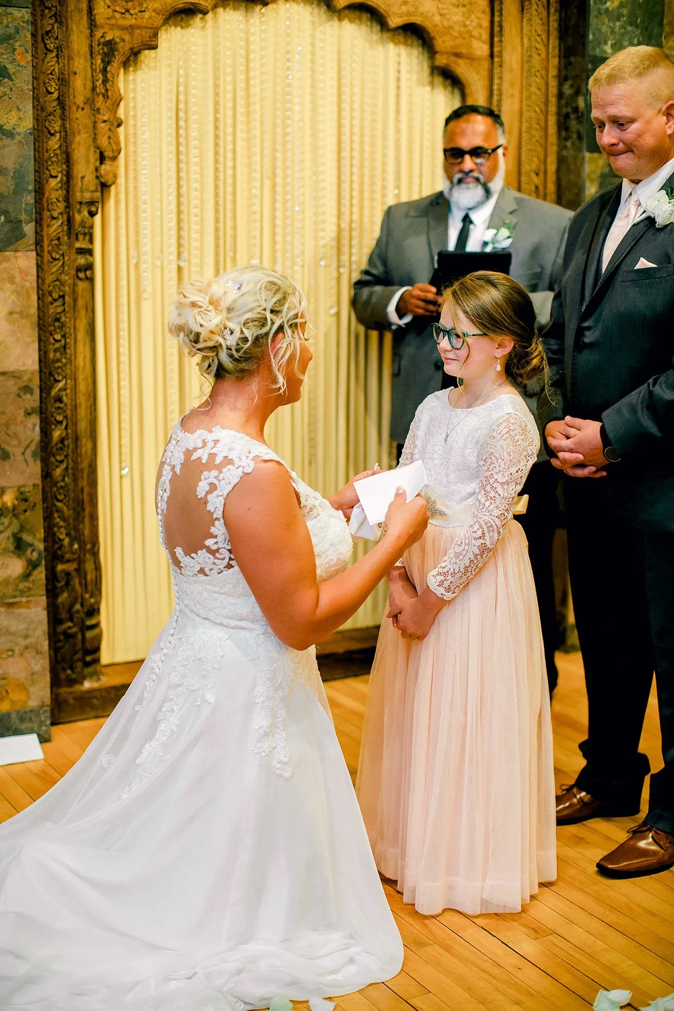 Jeff and Kasey The Palace Wedding - myheartcreative The bride gets on her knees and reads a touching note to the groom's daughter during the ceremony.