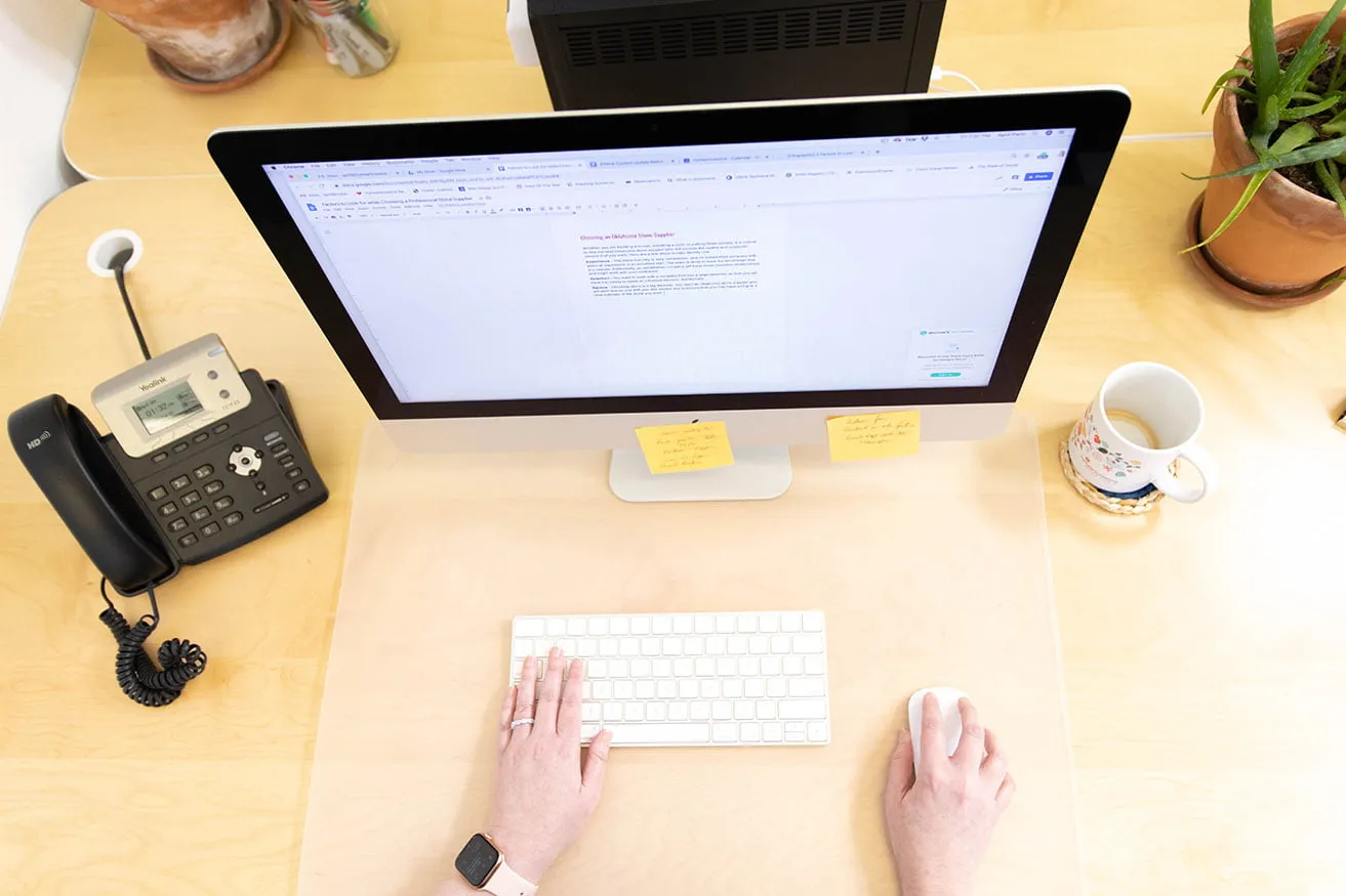 April writes a blog for a client at her desk. 