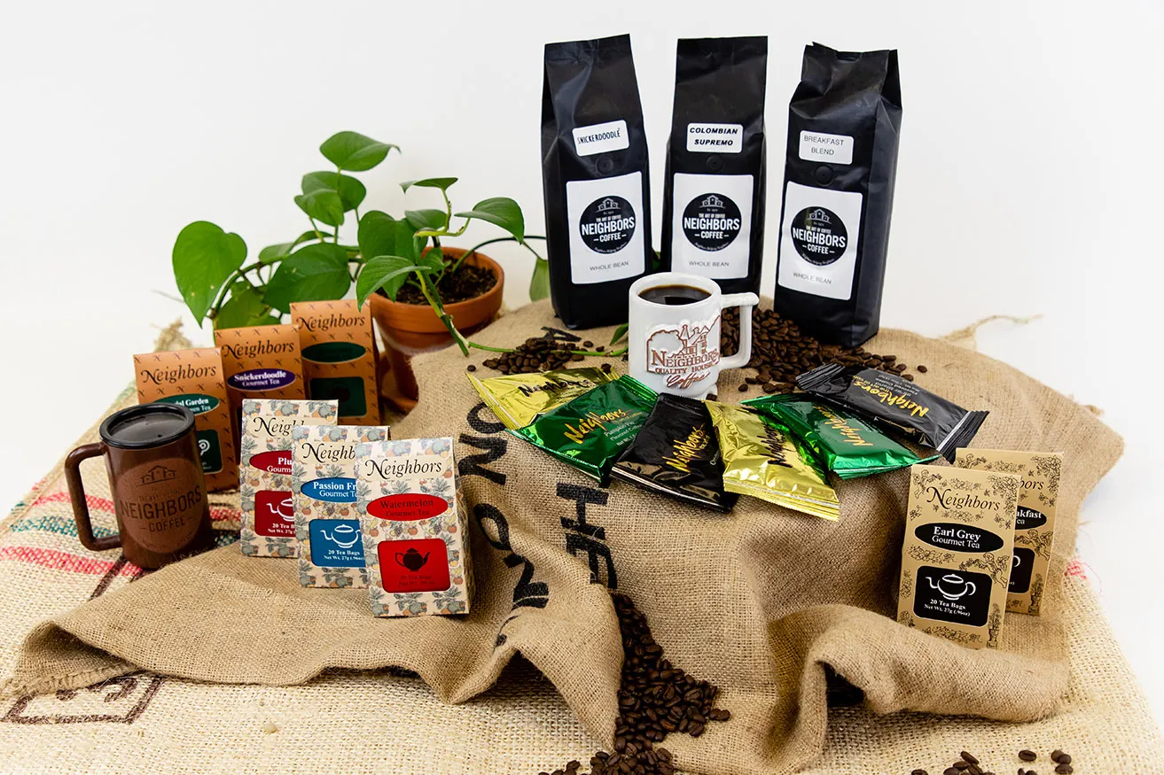 Why You Need OKC Commercial Photography - myheartcreative An assortment of Neighbors Coffee products, including bags of coffee and tea, placed on a burlap coffee bag on a white background.