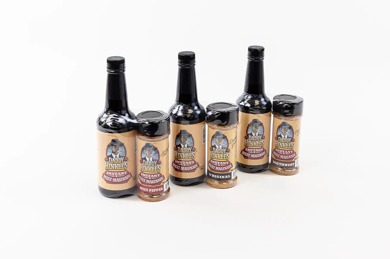 Why You Need OKC Commercial Photography - myheartcreative Three combo packages of Daddy Hinkles' Instant Meat Marinade and Spicy Pepper Seasoning photographed on a white background.