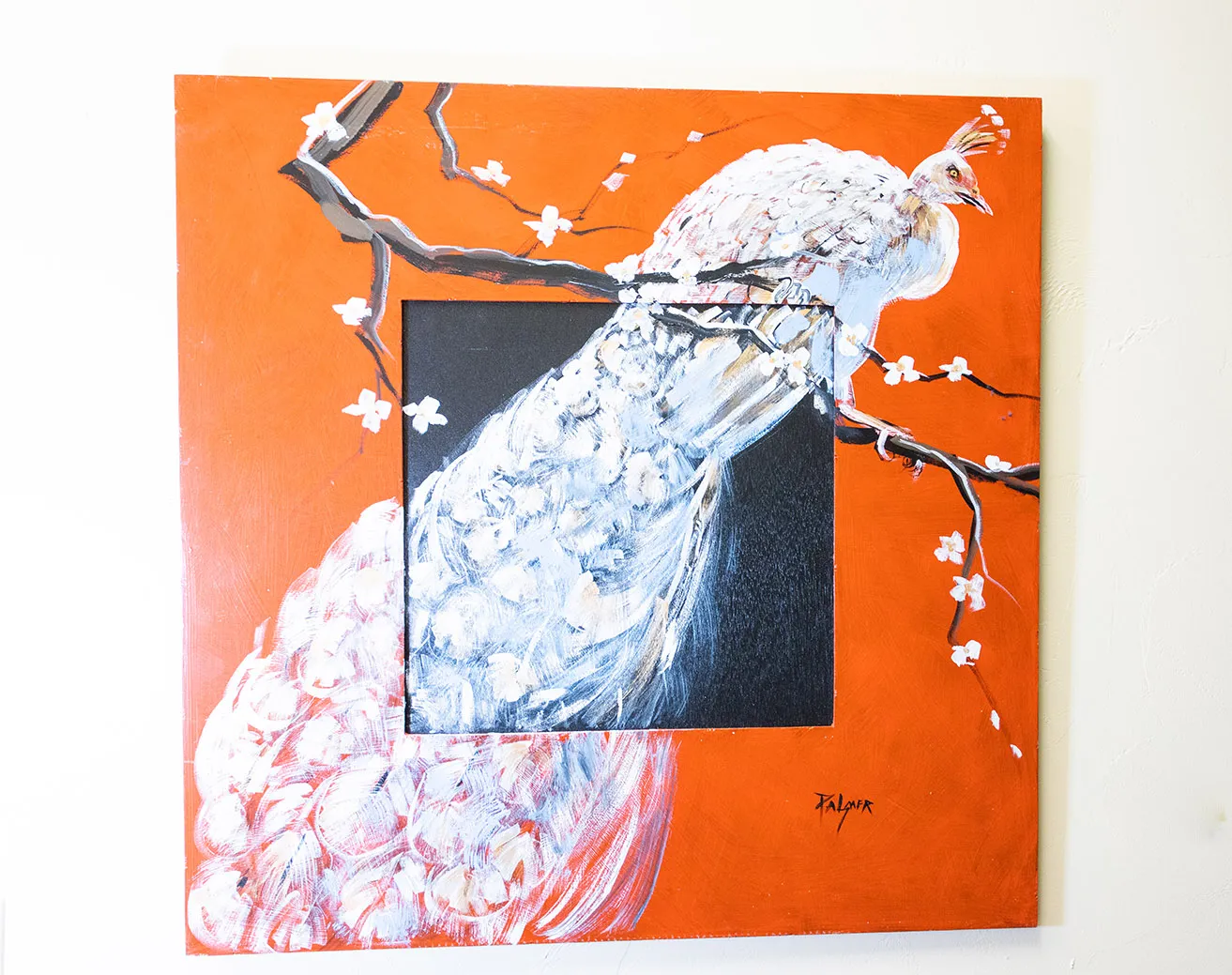 A painting of a white peacock sitting on a tree branch as painted by Dr. Bob Palmer. 