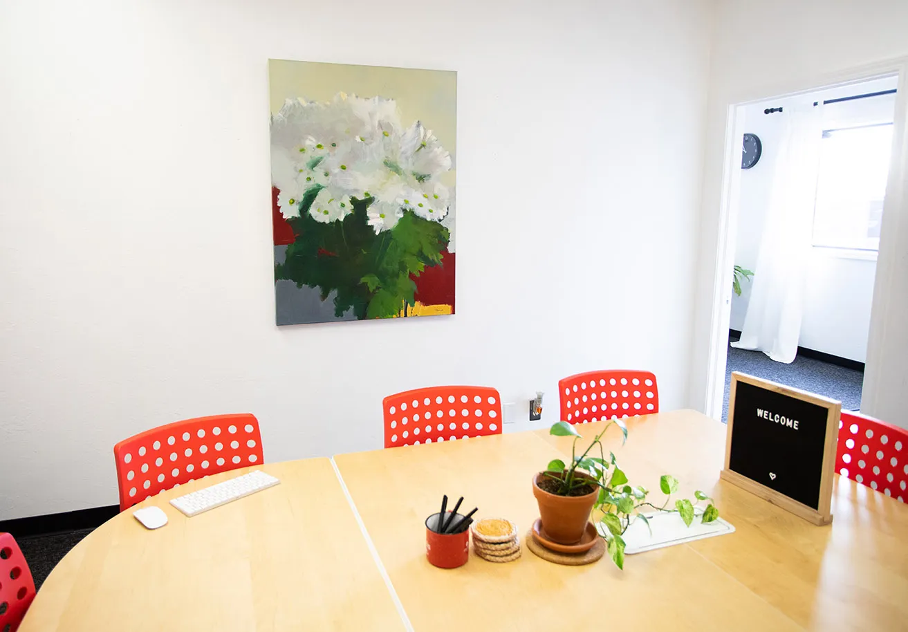 A floral painting hangs in the myheartcreative conference room. The painting was created by Behnaz Sohrabian. 
