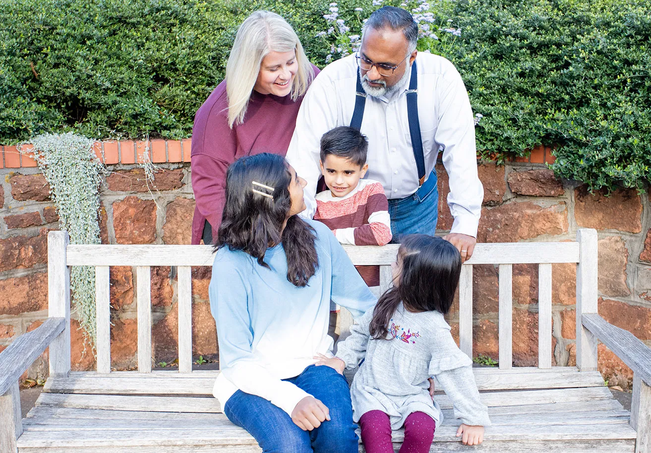 The Samuel family. Amy and Sam gaze at their three children, Katelyn, Madelynn, and Maximus. 