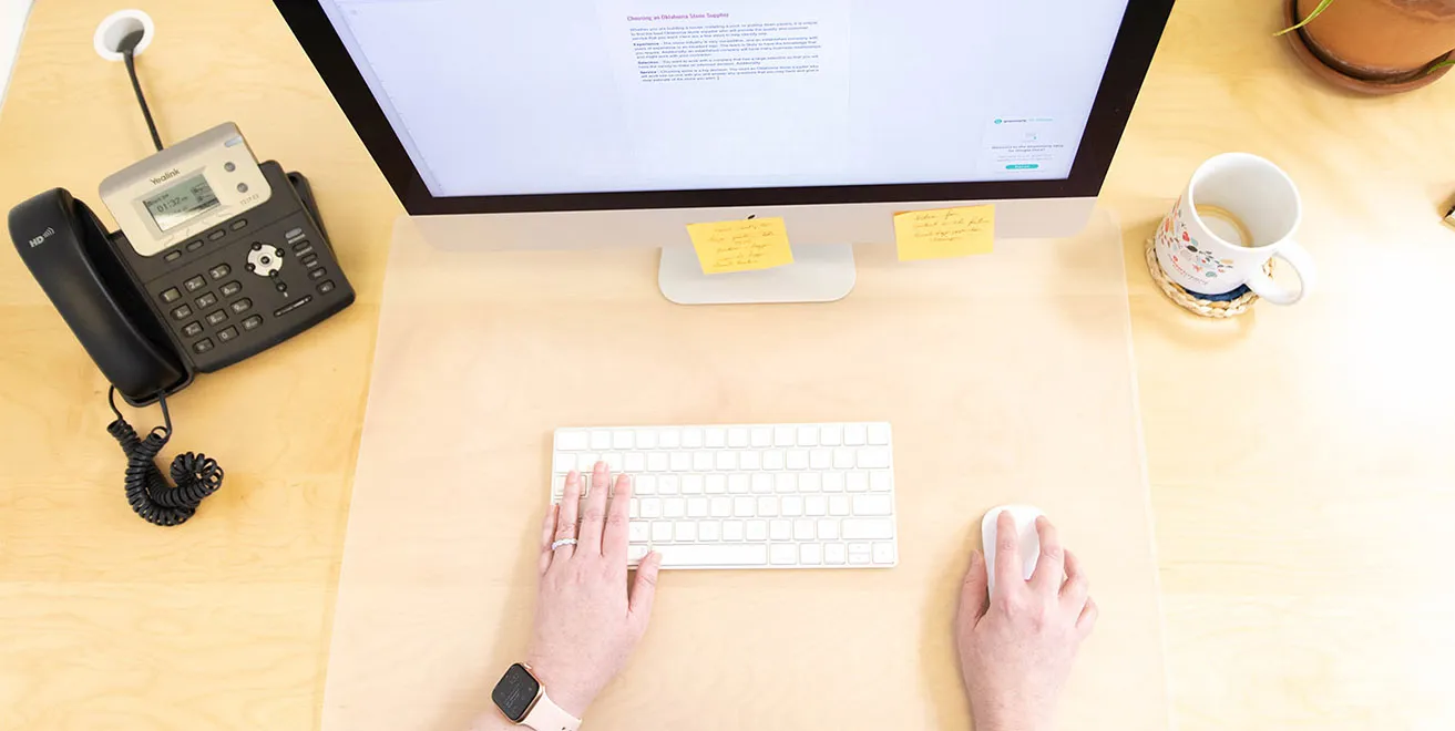 April types on her keyboard while working on client content at her desk. 